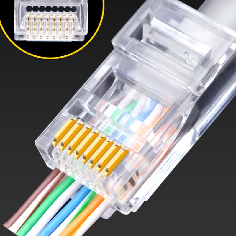 Clear RJ45 pass-through connector with eight conductors threaded out through its front face, with an inset showing the eight open holes in the front of the plug