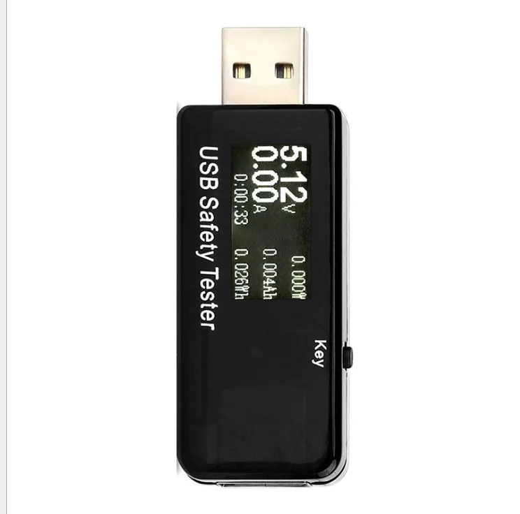 Black inline USB-A power meter standing upright, its display showing voltage, current, elapsed time, power and accumulated capacity
